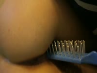 Kinky bitch using a comb as her dildo
